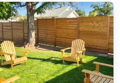 Repaired wood fence in a Bucks County backyard